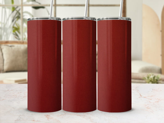 Three tall, plain red tumblers with straws on a marble surface.