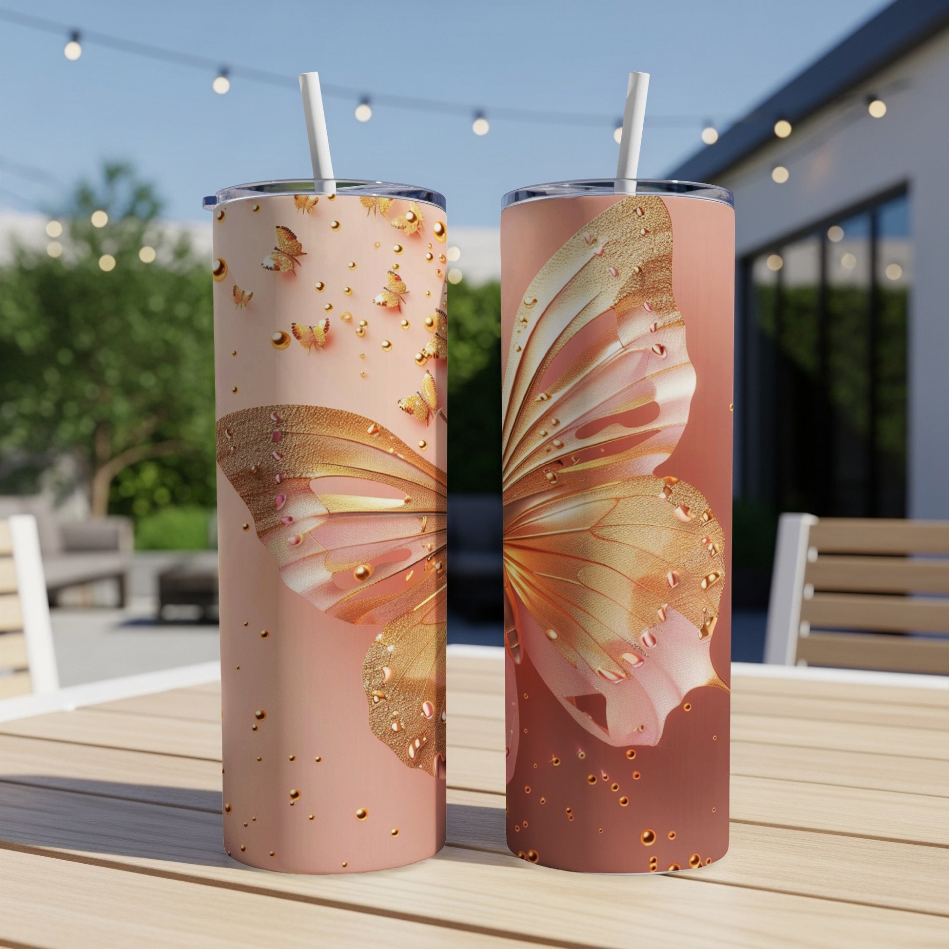 Two tumblers with pink and gold butterfly and water drop designs.