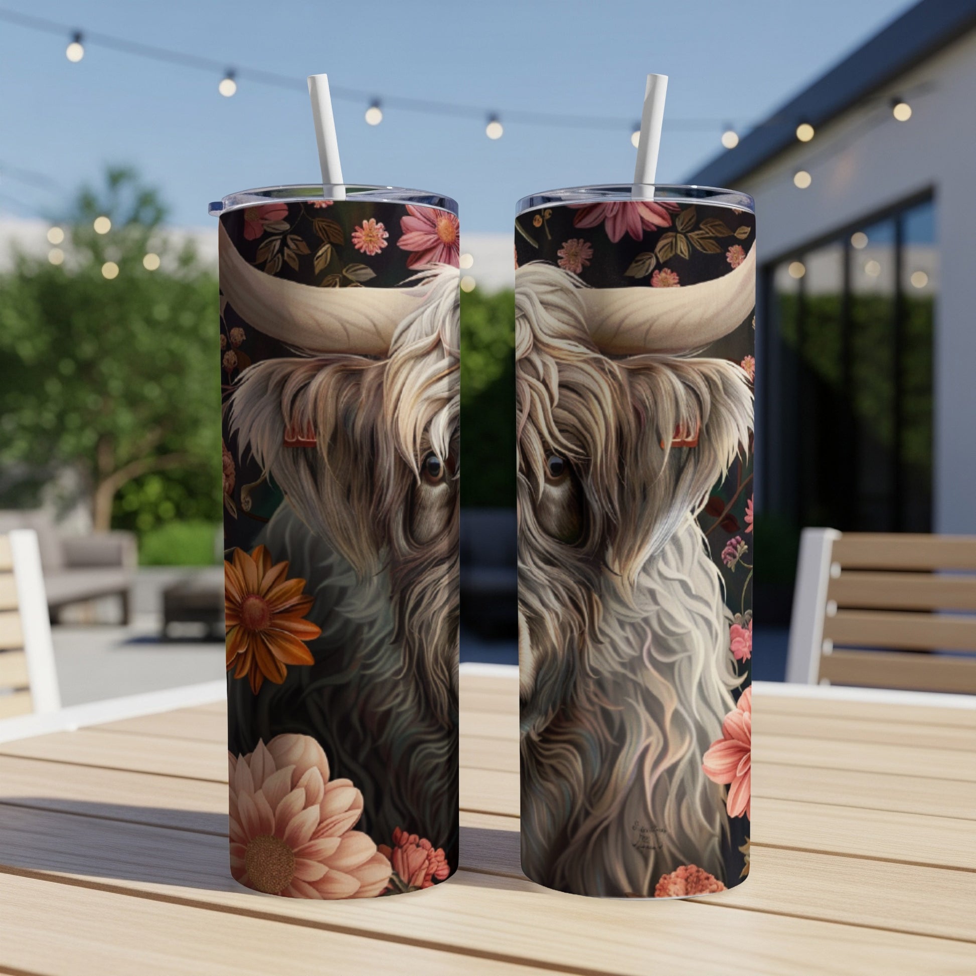 Highland cow with floral accents on a patterned tumbler.