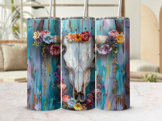 Longhorn skull with floral crown on distressed teal wood background.