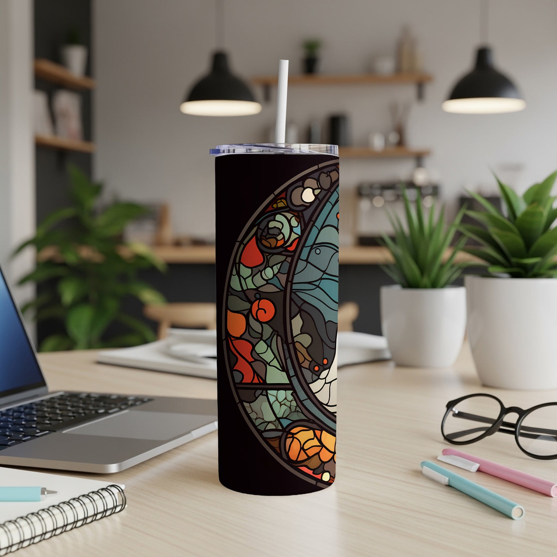 Stained glass celestial moon design on a black tumbler with a white straw.