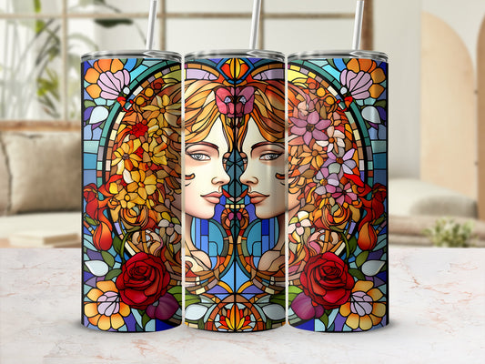Two stylized female faces in stained glass with floral and geometric patterns.