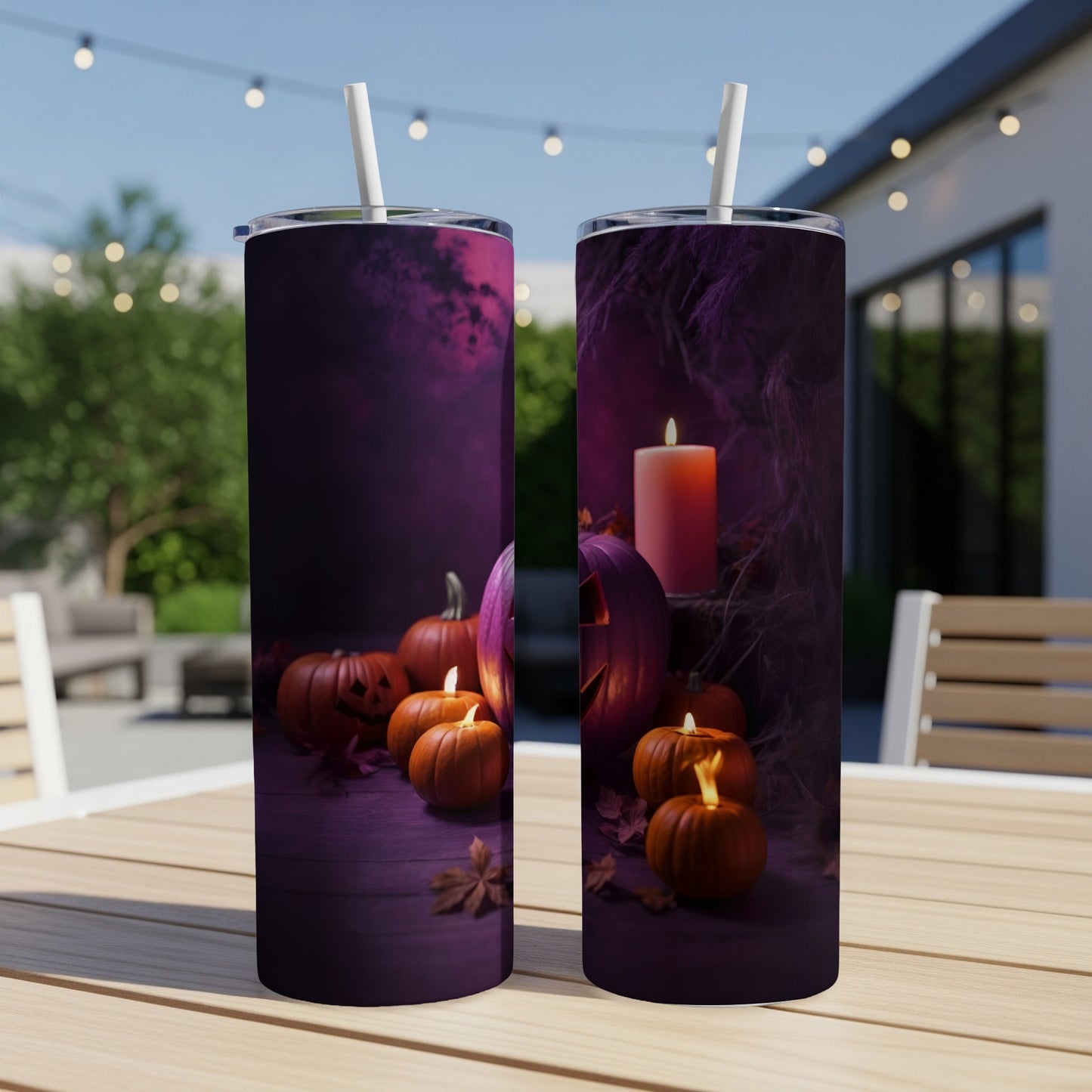 Two tumblers featuring a spooky Halloween design with pumpkins and a candle.