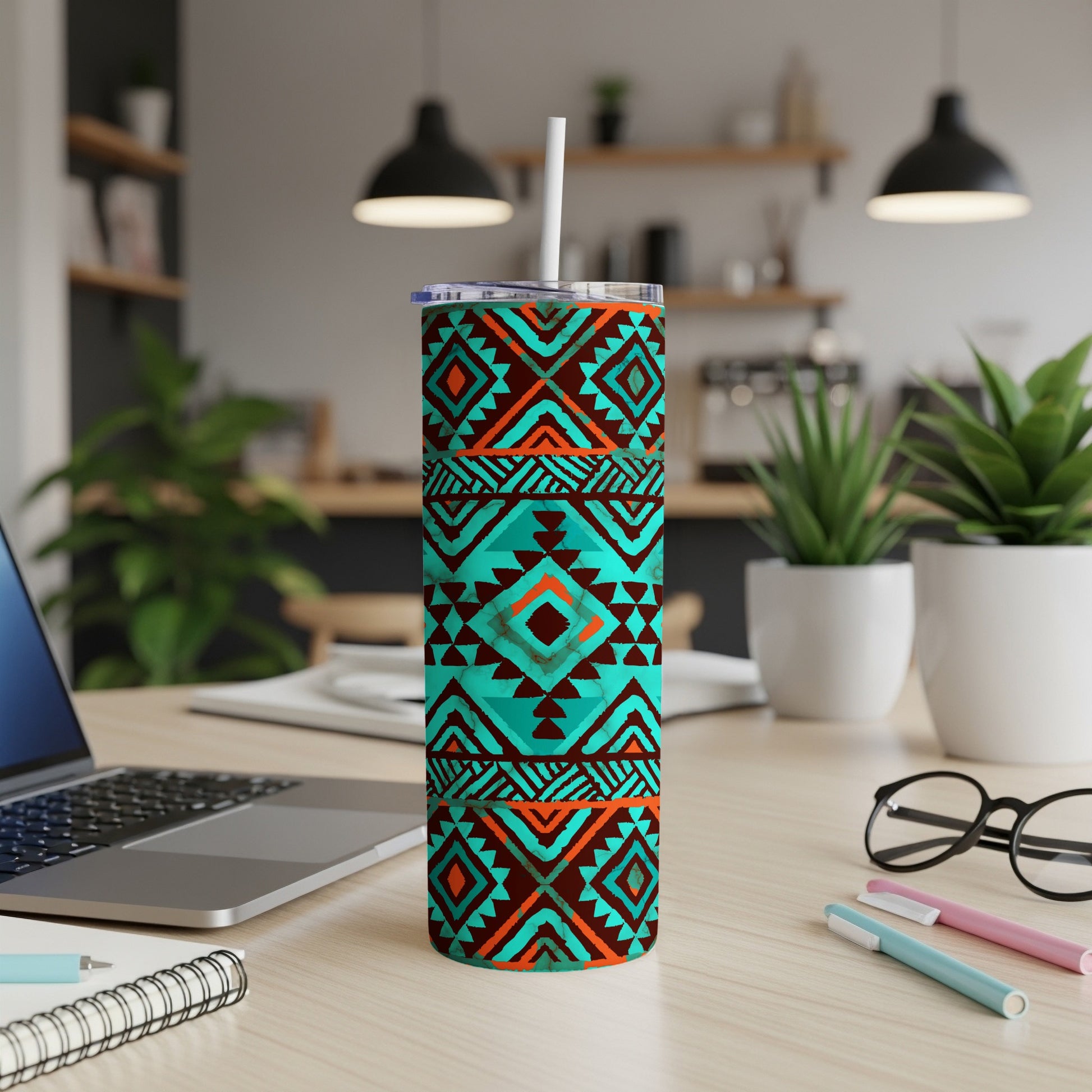 Teal and orange geometric pattern tumbler with a white lid and straw.