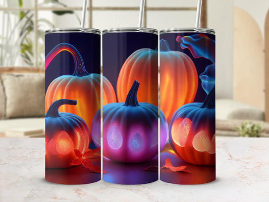 Tumbler with three pumpkins, one with glowing pattern.