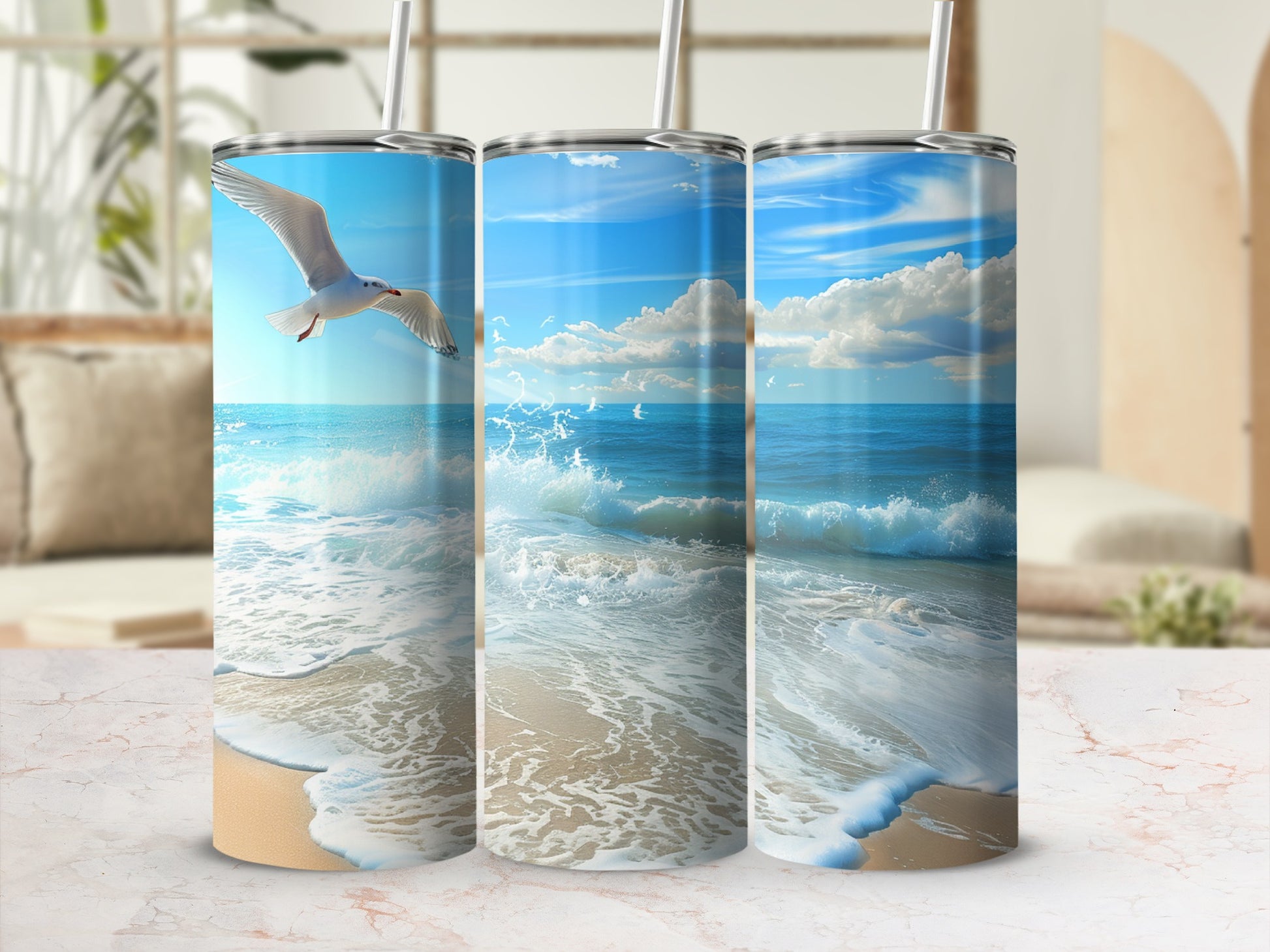 Three tumblers showing a beach scene with a seagull in flight.