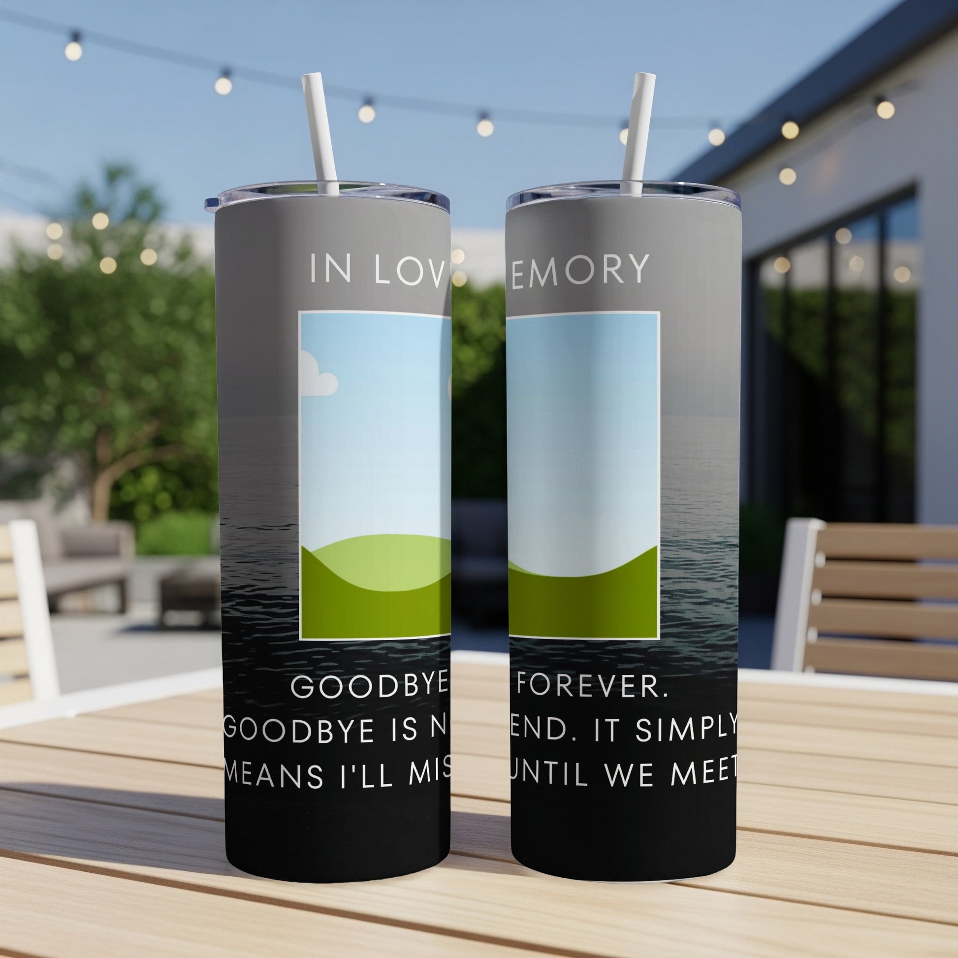 Two tumblers with "In Loving Memory" and memorial text on a patio table.