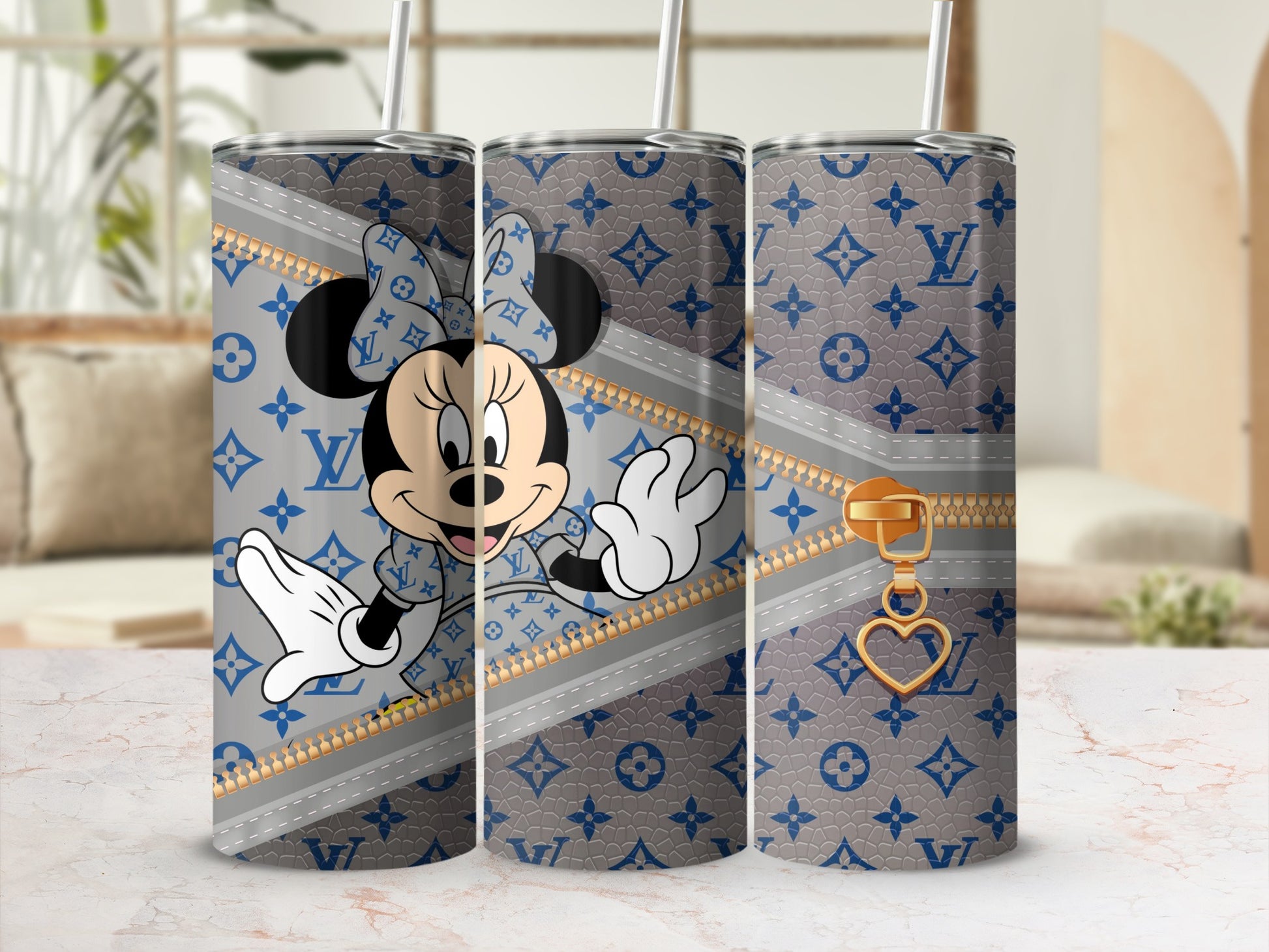 Minnie Mouse on a grey and blue monogrammed tumbler with a gold zipper and heart charm.