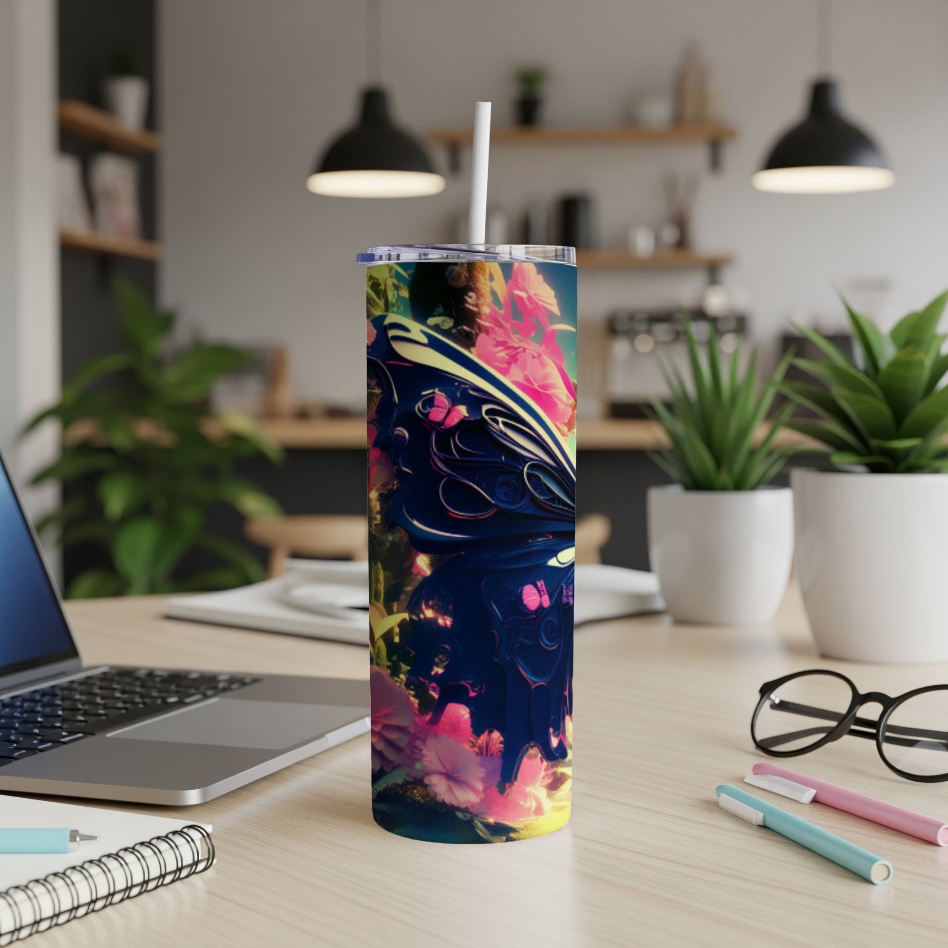 Tall tumbler with butterfly and floral design on a wooden desk.