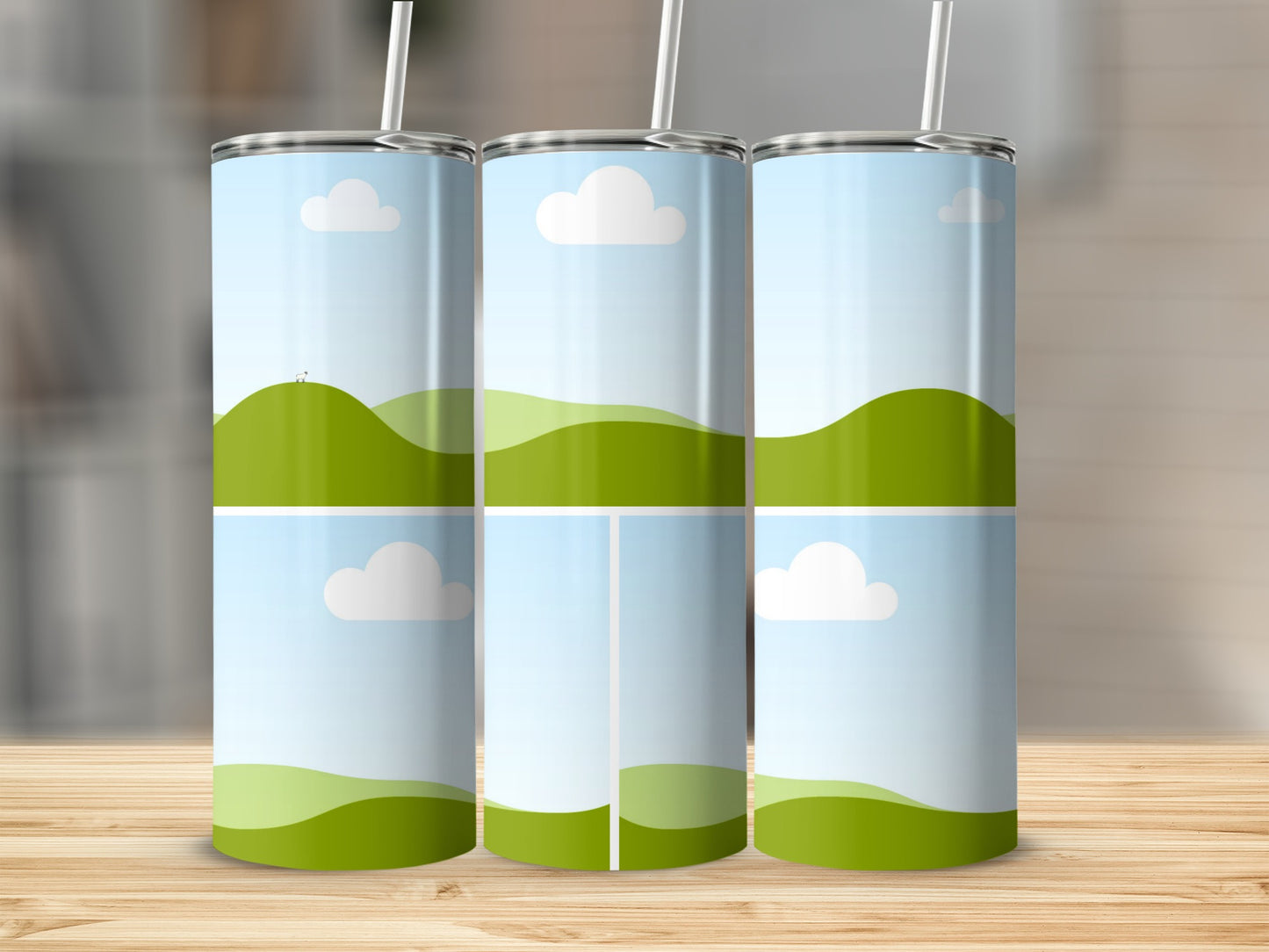 Three tumblers with rolling green hills and sky graphic designs.