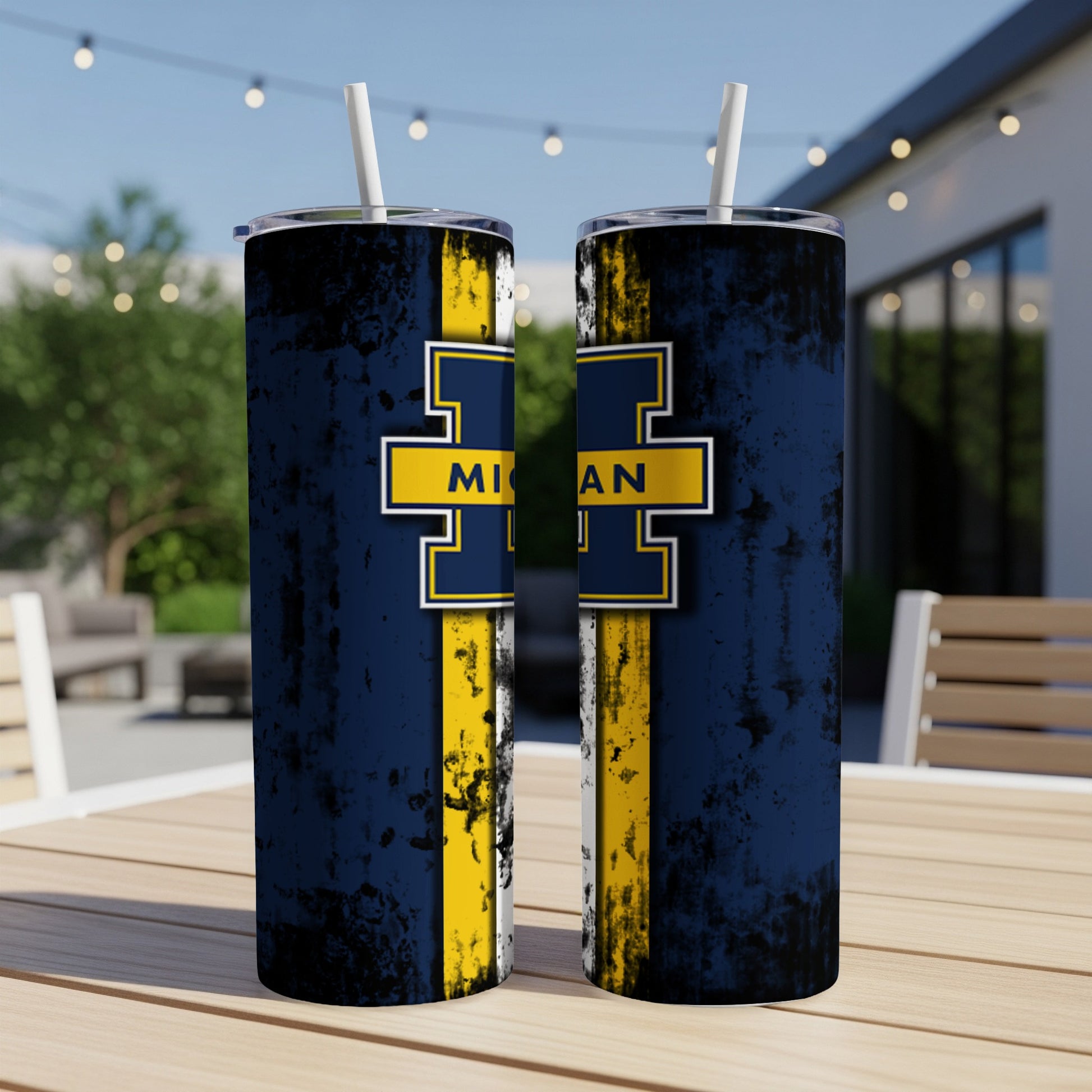 Two navy blue tumblers with a yellow Michigan Wolverines M logo and distressed texture.