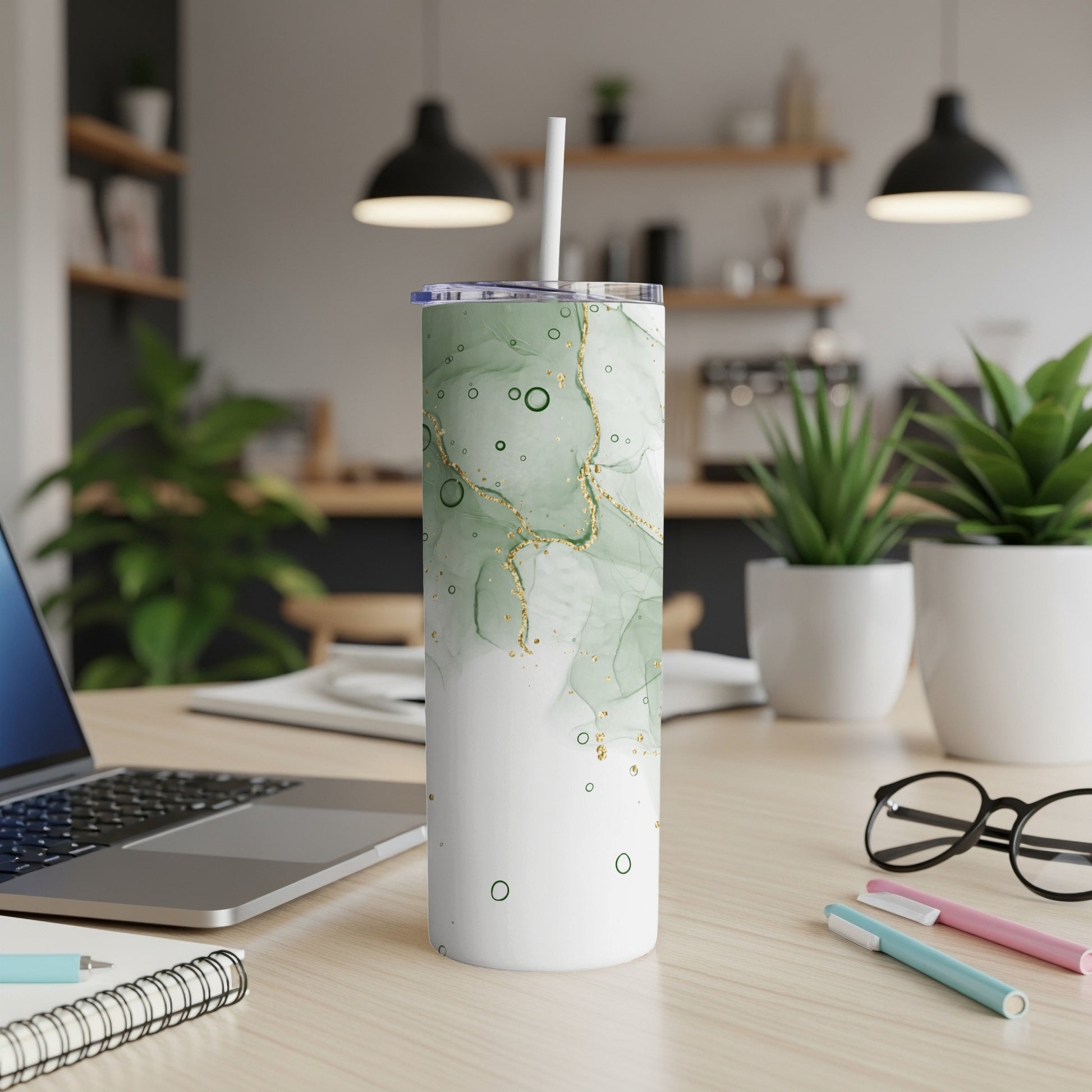 Green and white marble pattern tumbler with gold accents and straw.