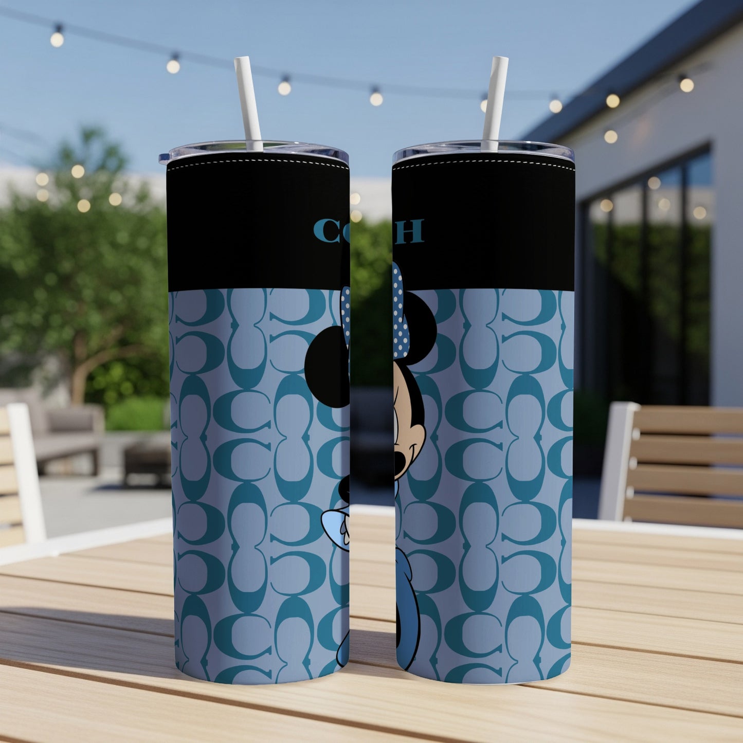 Two tumblers with Minnie Mouse, Coach logo, and light blue monogram pattern.