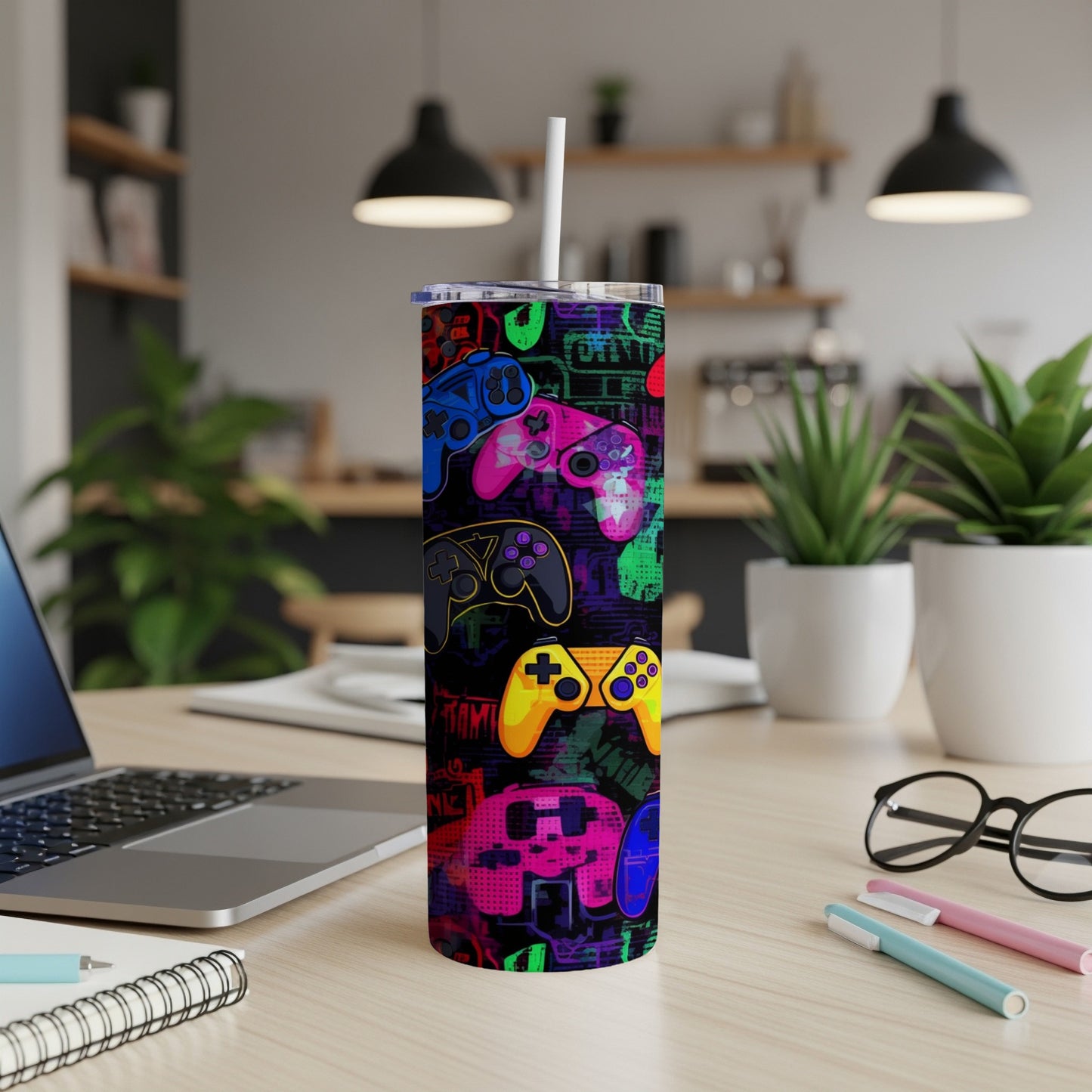 Colorful video game controllers pattern on a white tumbler with a straw.