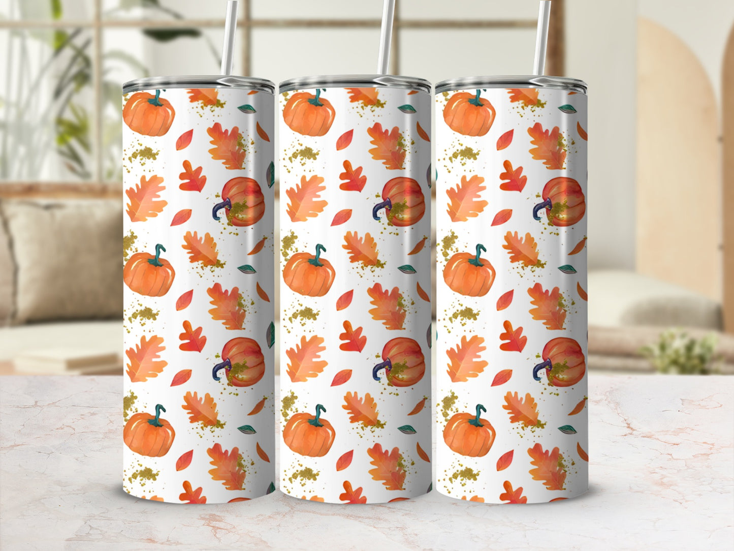 Three tumblers with a fall leaf and pumpkin pattern.