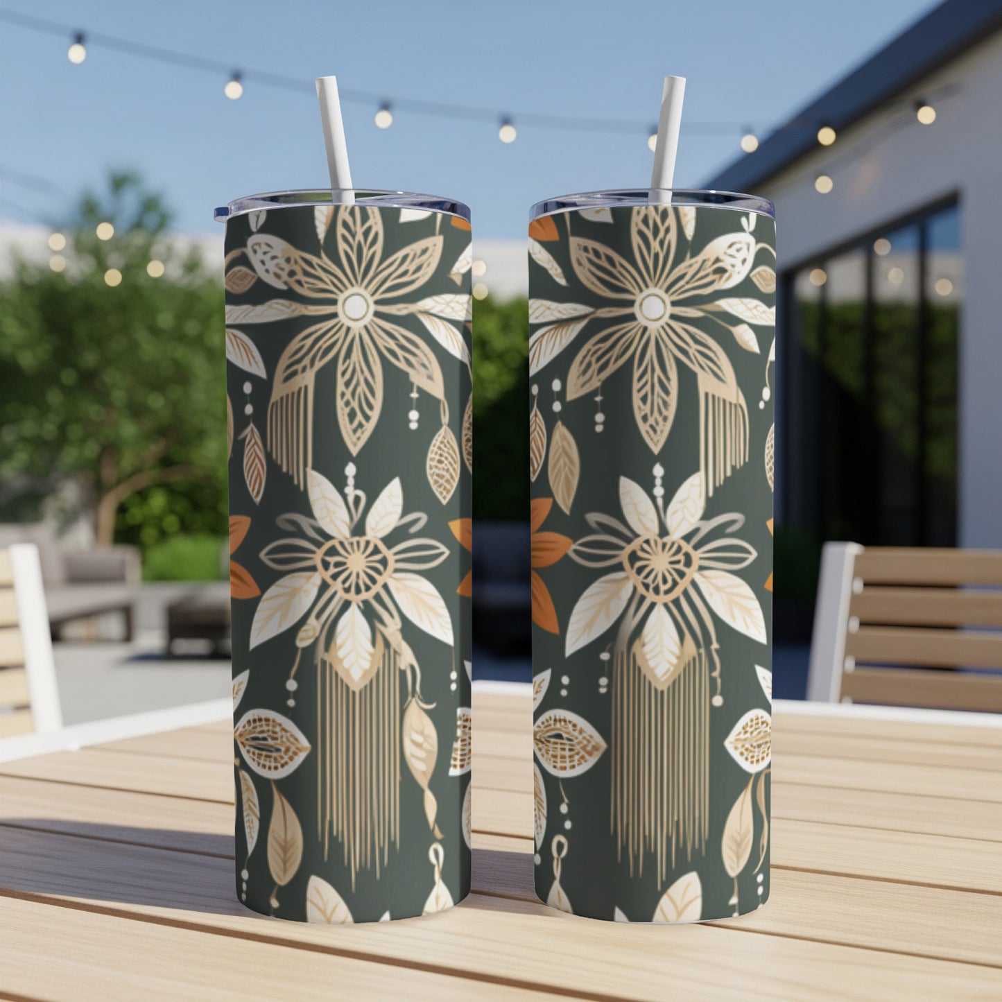 Two dark green tumblers with a gold and white floral and feather pattern.