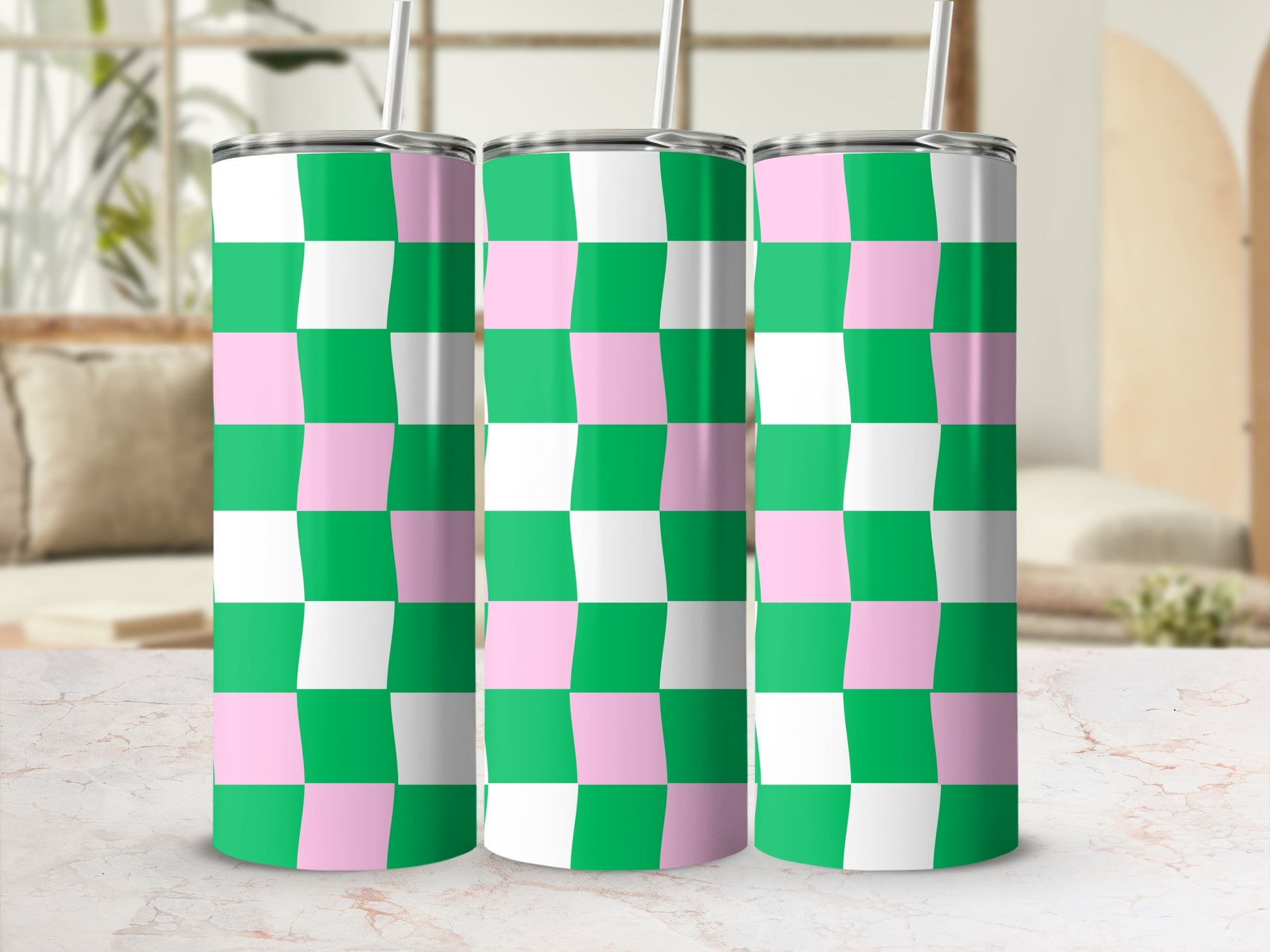 Three tall tumblers with a pink and green checkerboard pattern.
