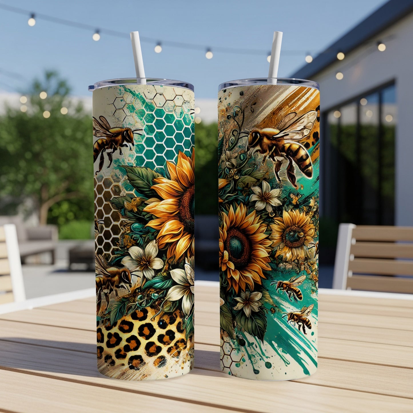 Two sunflower and bee tumblers with leopard print accents sit on a table.