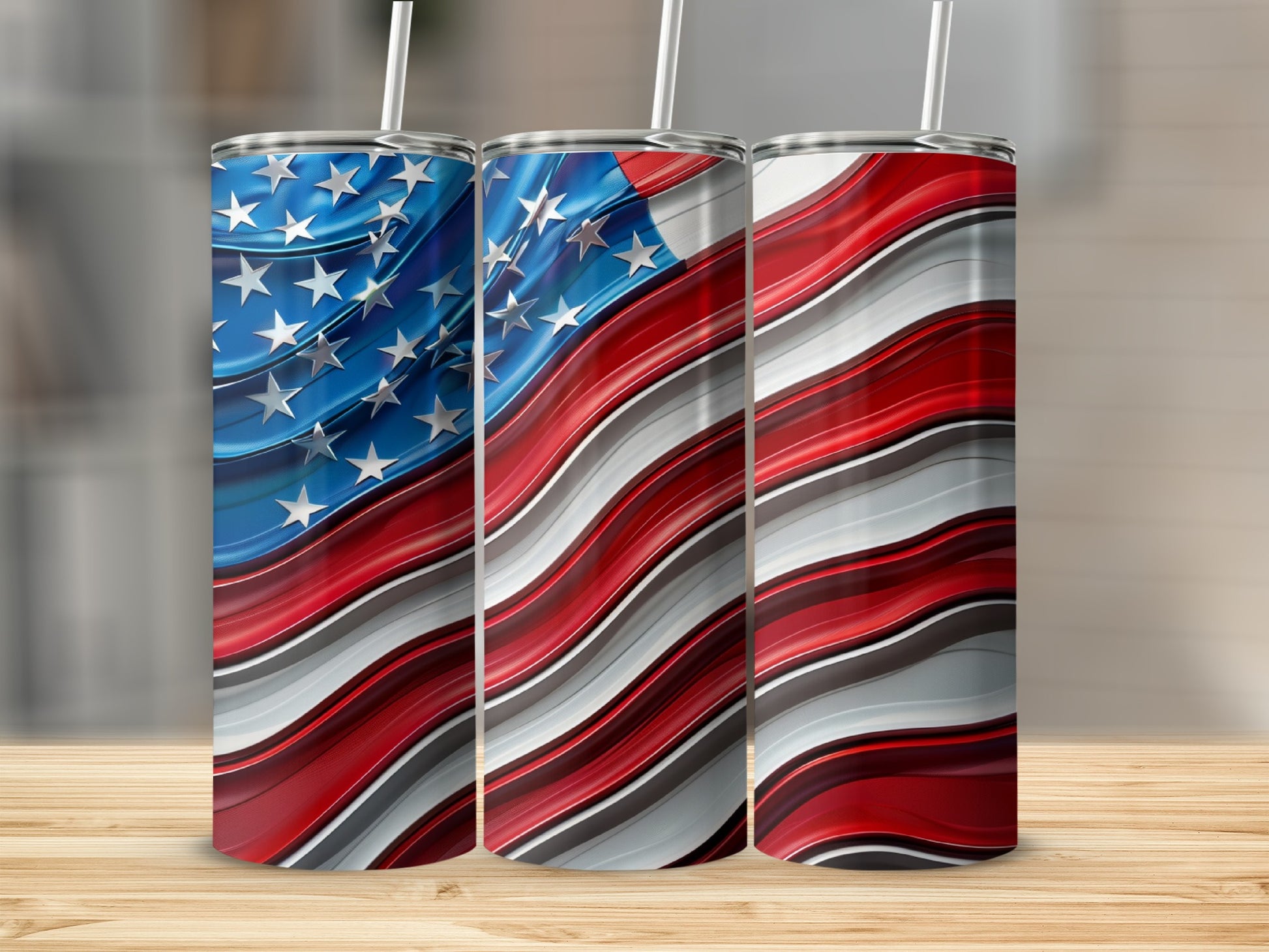 Three tumblers with a wavy American flag design and straws.