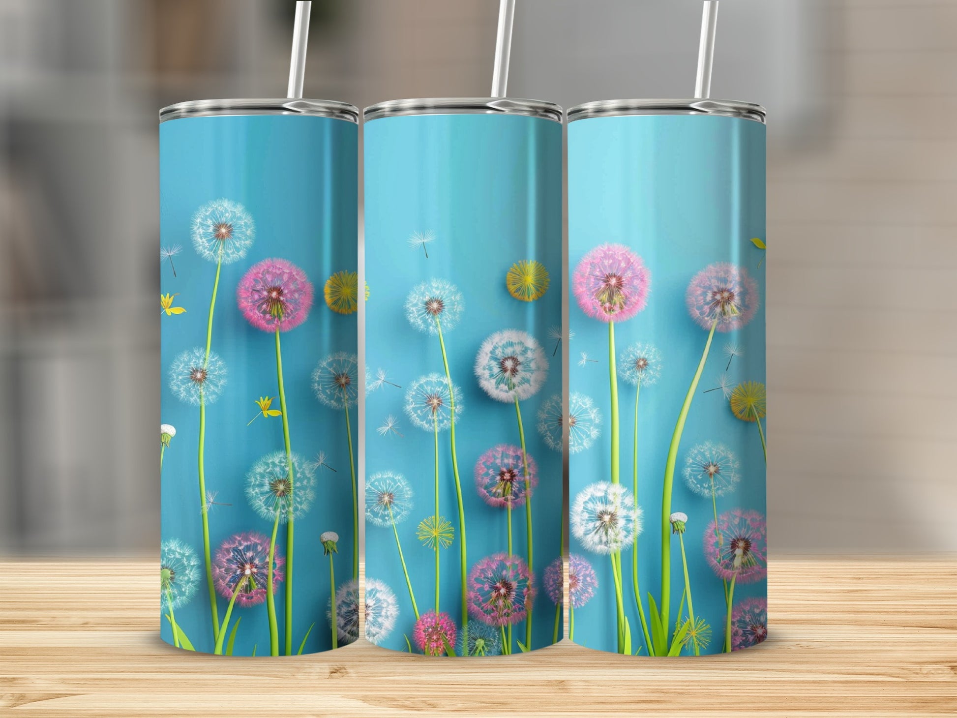 Three tall, skinny tumblers with dandelion designs on a light blue background.
