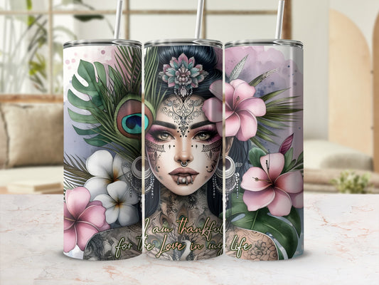 Tumbler with tattooed woman, flowers, peacock feather, and "I am thankful for the love in my life" text.