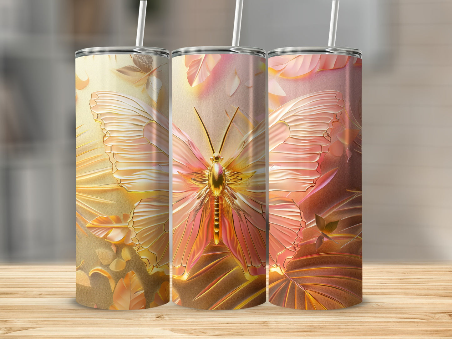 Three tumblers with embossed golden butterfly and floral designs.