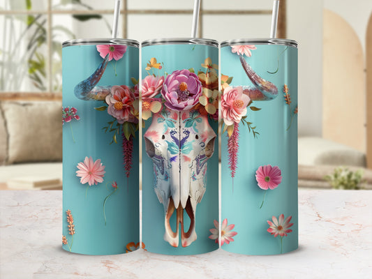 Turquoise tumbler with floral bull skull design and straw.