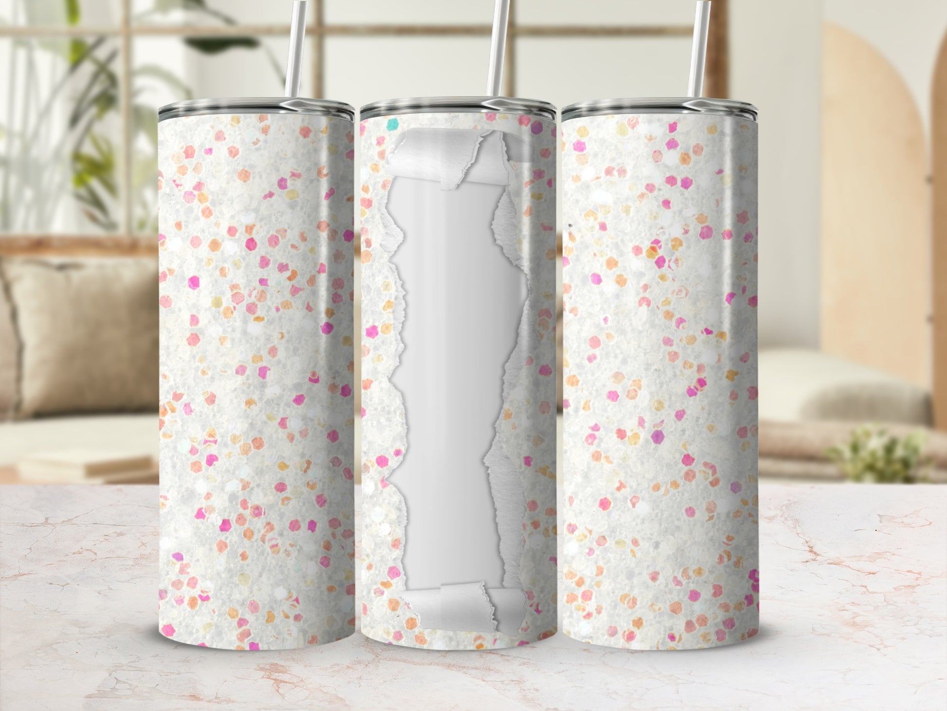 Three glitter-covered tumblers with peeling white centers and straws.