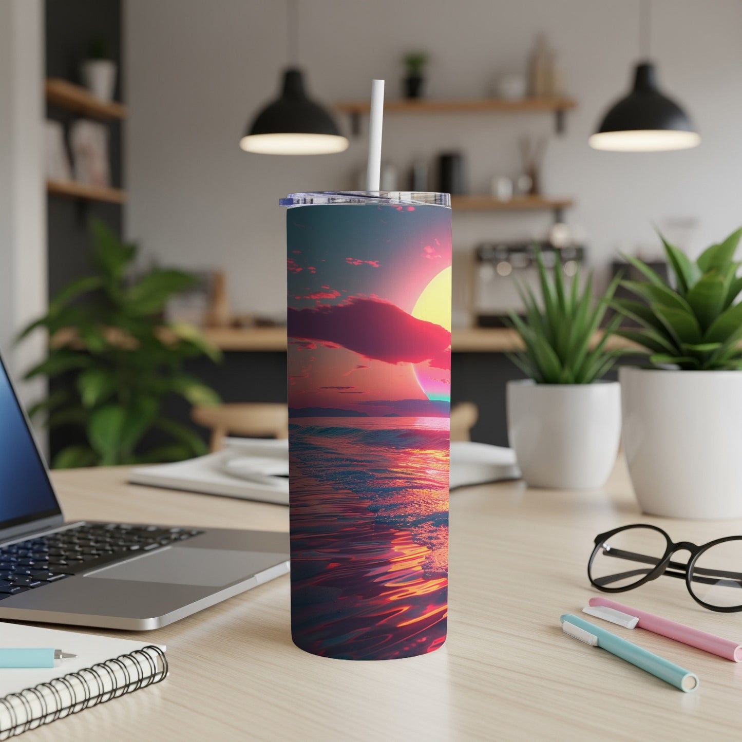 Sunset over ocean reflected on a travel tumbler on desk.