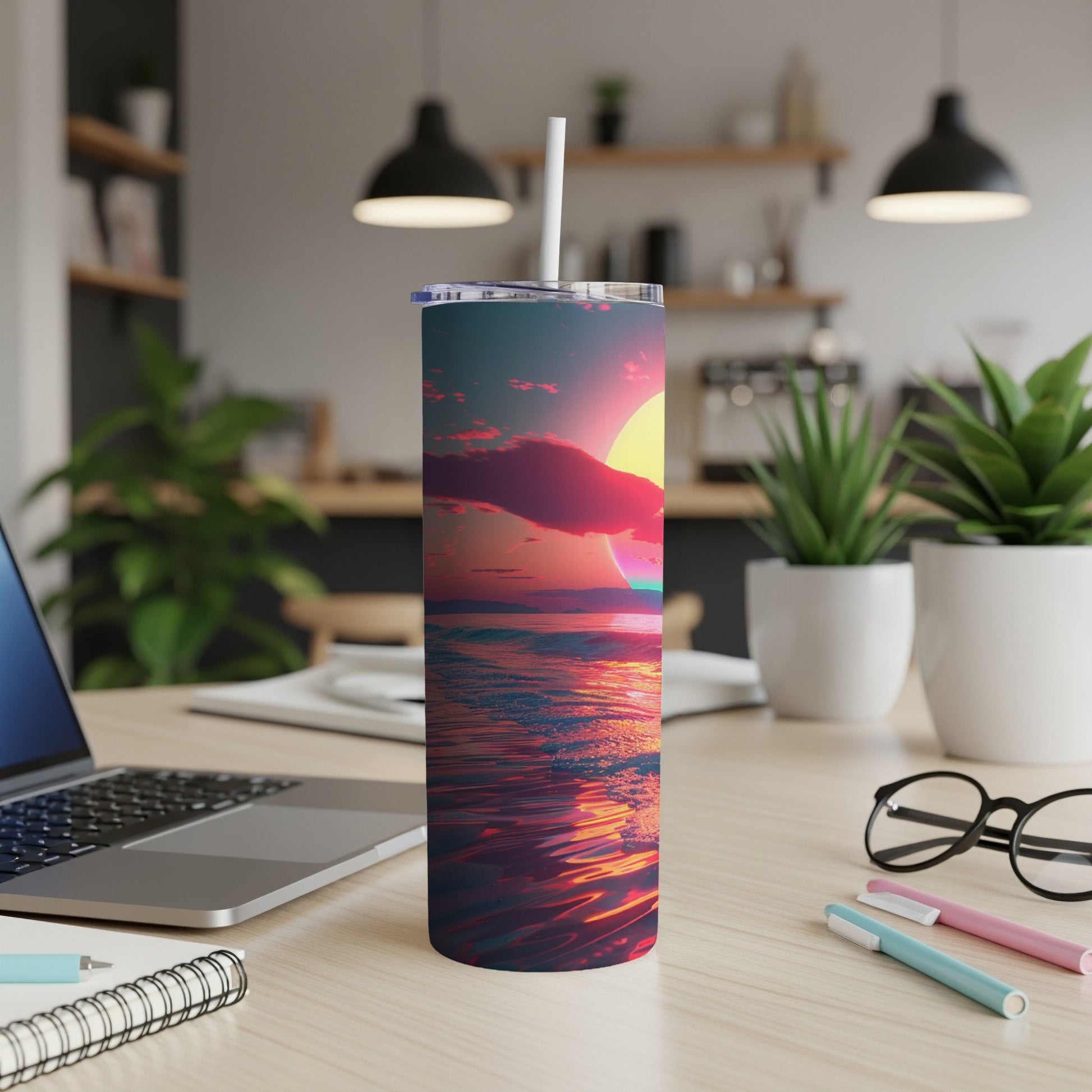 Sunset over ocean reflected on a travel tumbler on desk.