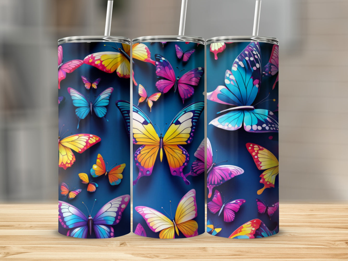 Three tumblers with colorful butterfly designs against a dark blue background.