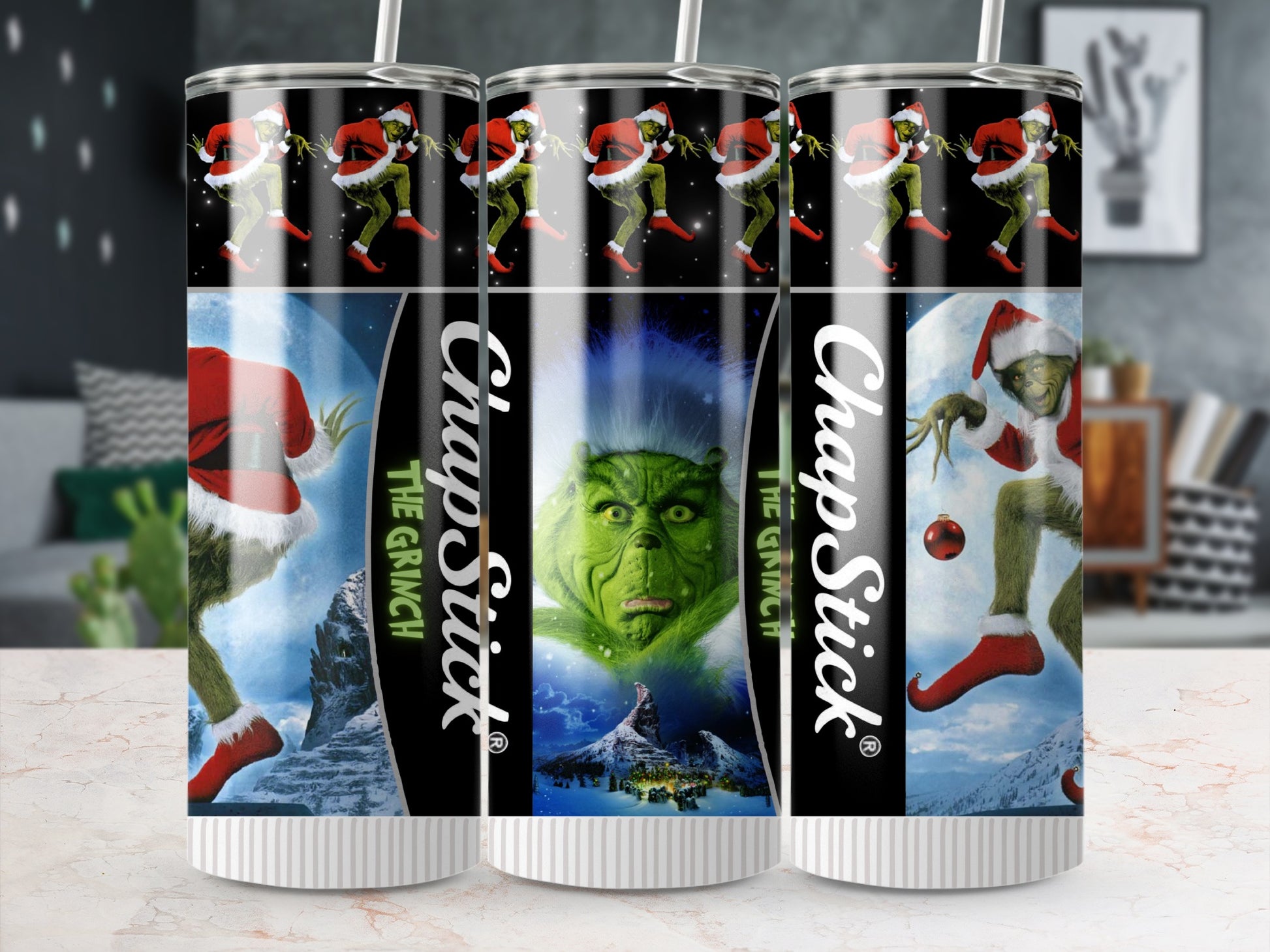 ChapStick tumbler with the Grinch, Santa hats, and snow-covered mountains.
