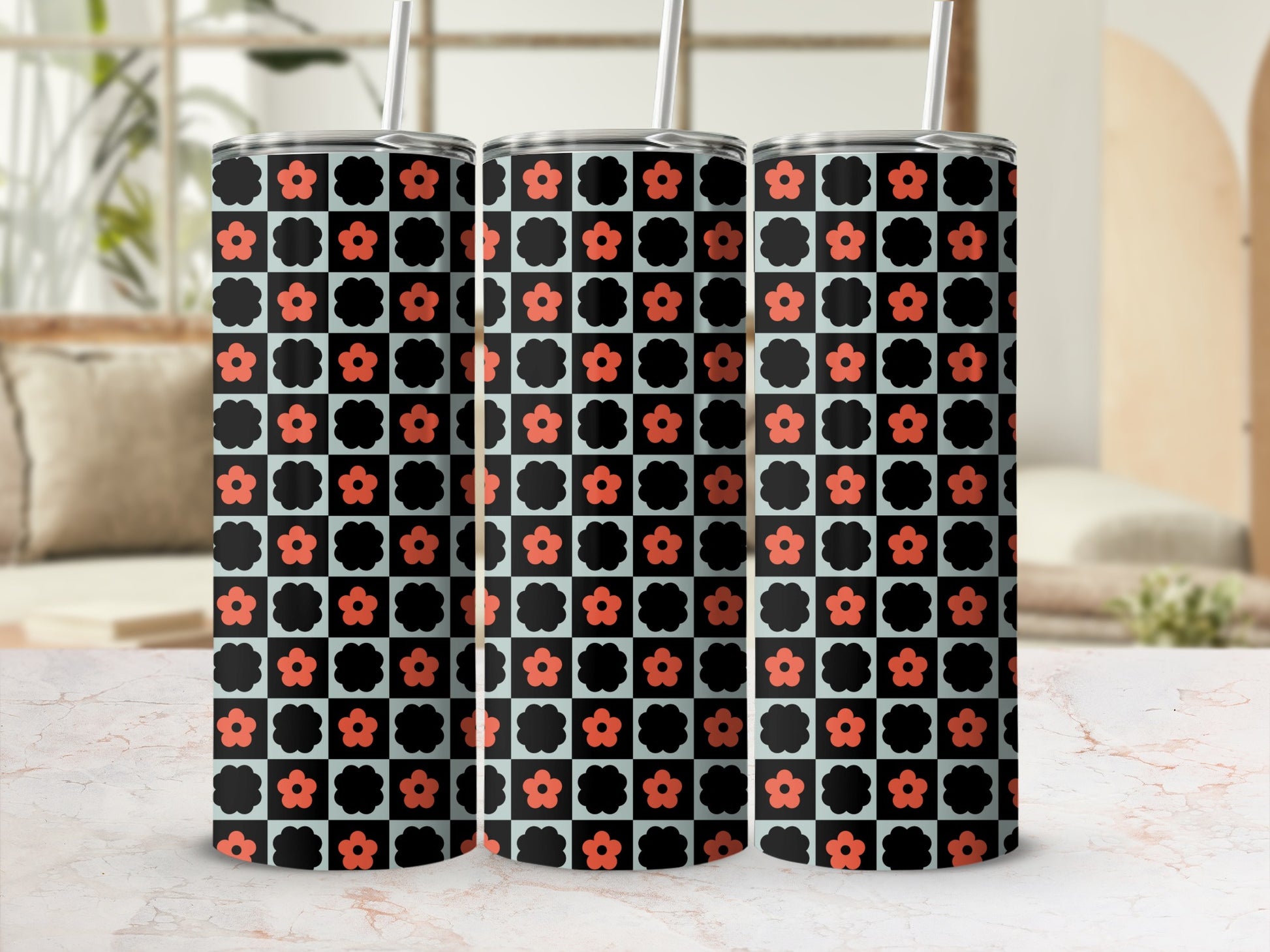 Three tumblers with a black and orange floral checkered pattern.