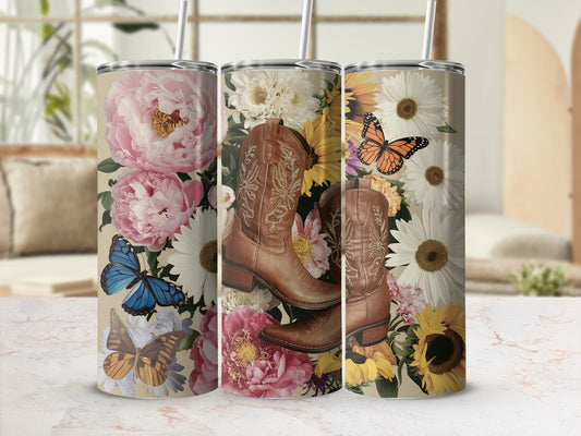 Floral cowboy boots with butterflies and sunflowers on a marble surface.
