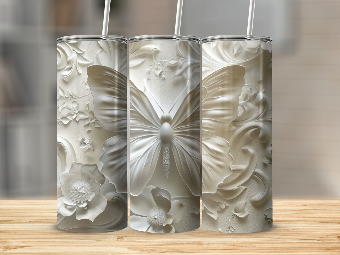 Three white embossed tumblers with butterfly and floral designs.