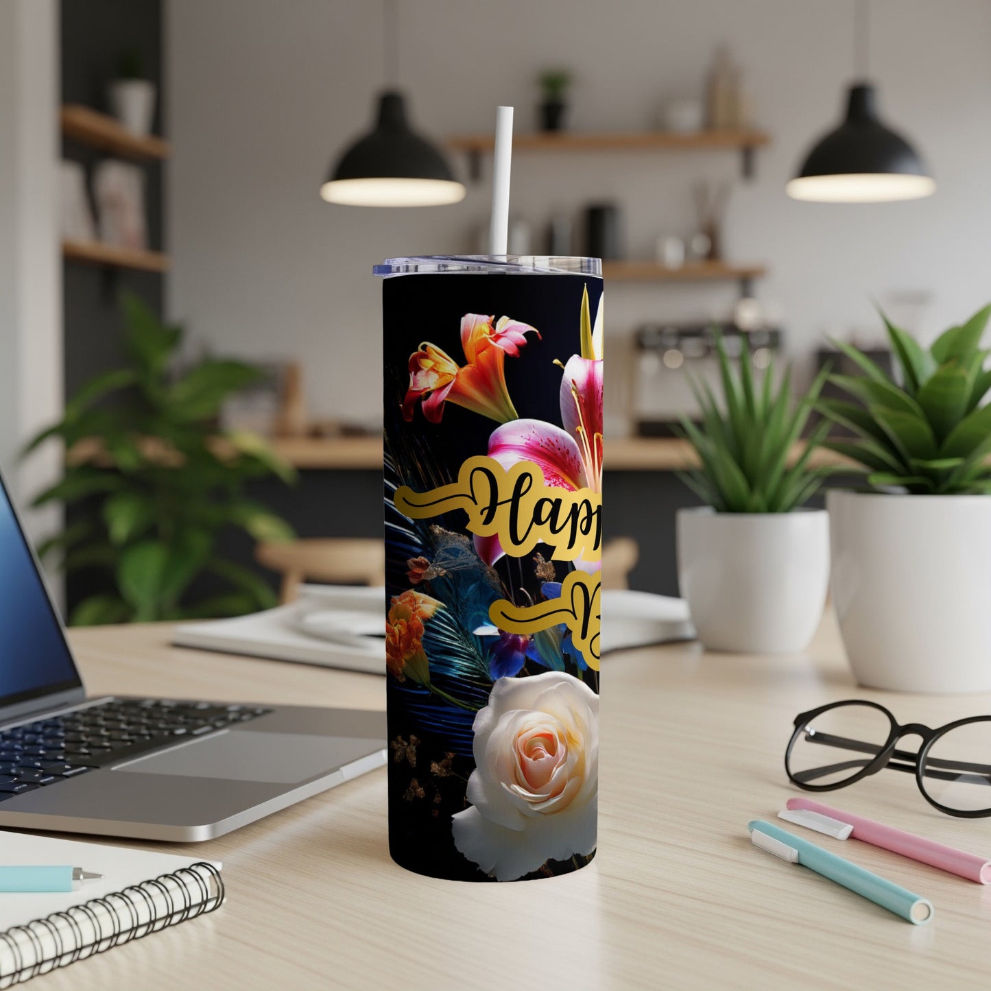 Tumbler with "Happy Mother's Day" text and floral design on a desk.