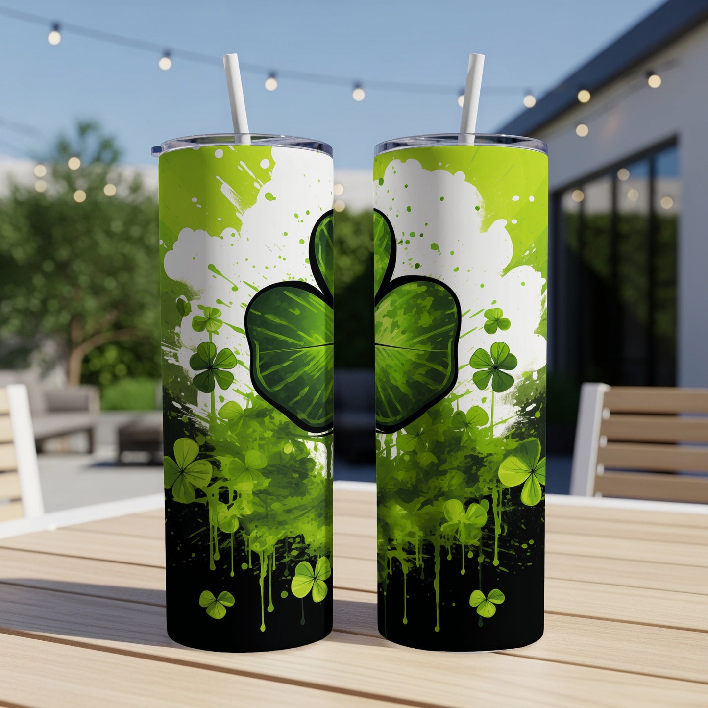 Two St. Patrick's Day themed tumblers with shamrocks and green splatter.