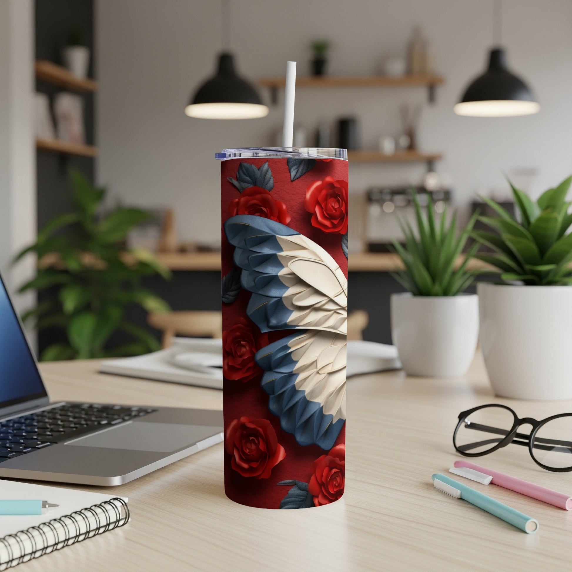 Red tumbler with white, blue, and tan patterned wings and roses.