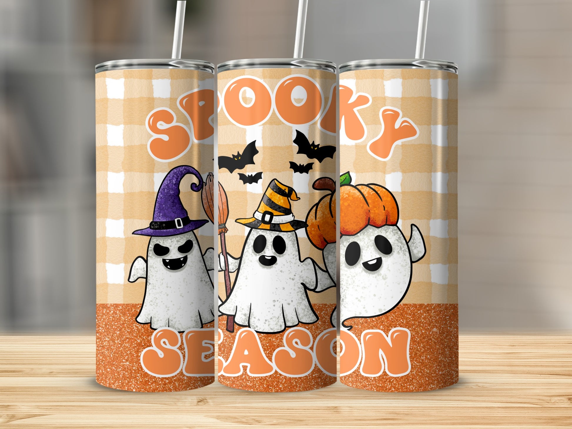 Three tumblers with a spooky Halloween design featuring ghosts, bats, and pumpkins.