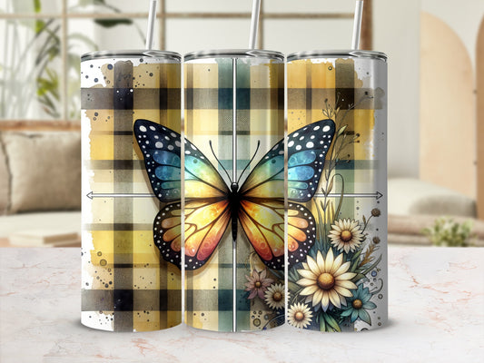Tumbler with butterfly and floral pattern on yellow plaid background.