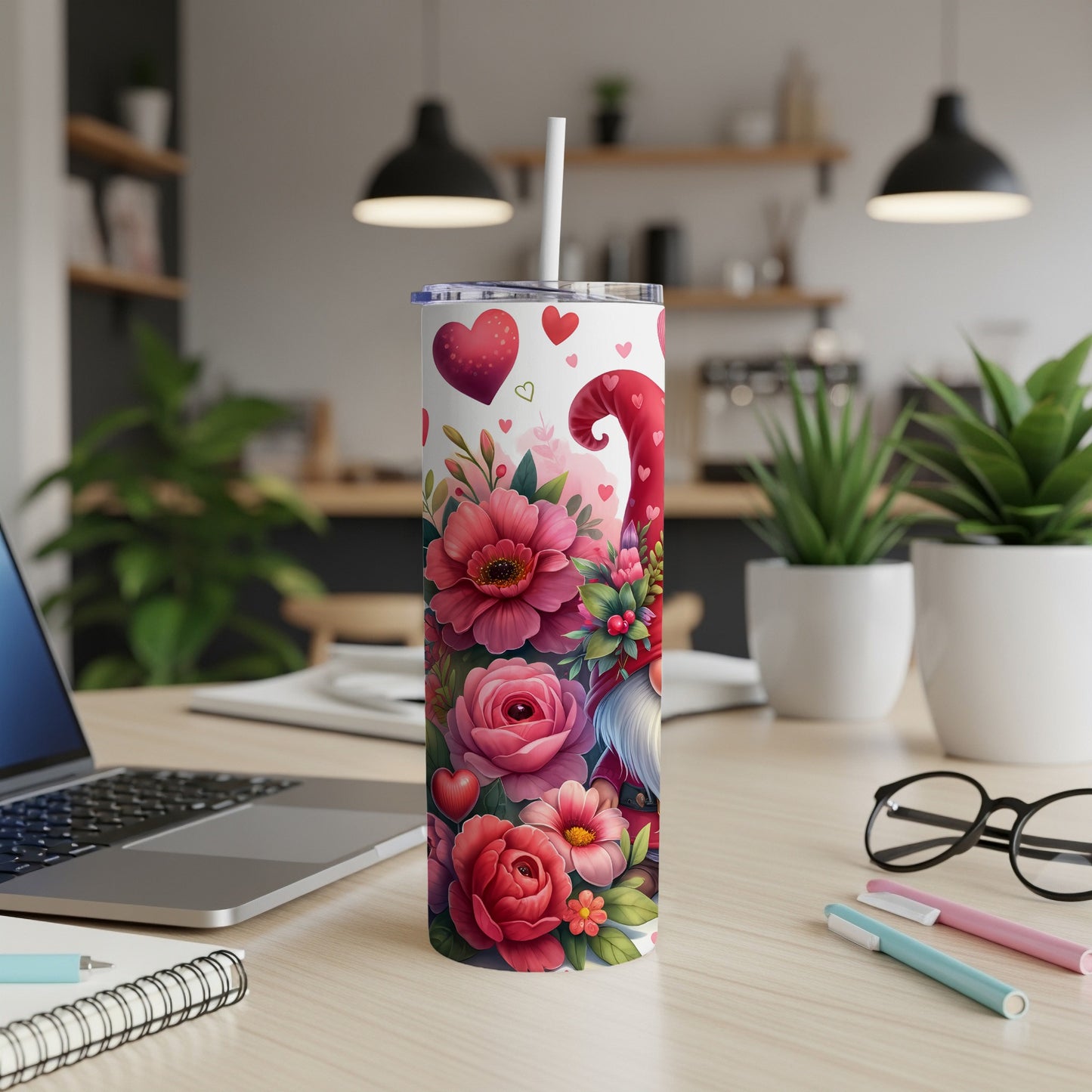 Gnome, hearts, and floral pattern on a white tumbler with straw.
