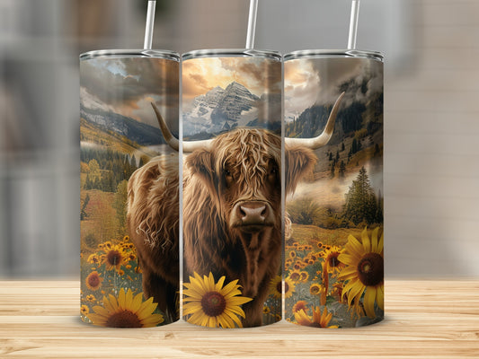 Highland cow in sunflower field with mountain backdrop.
