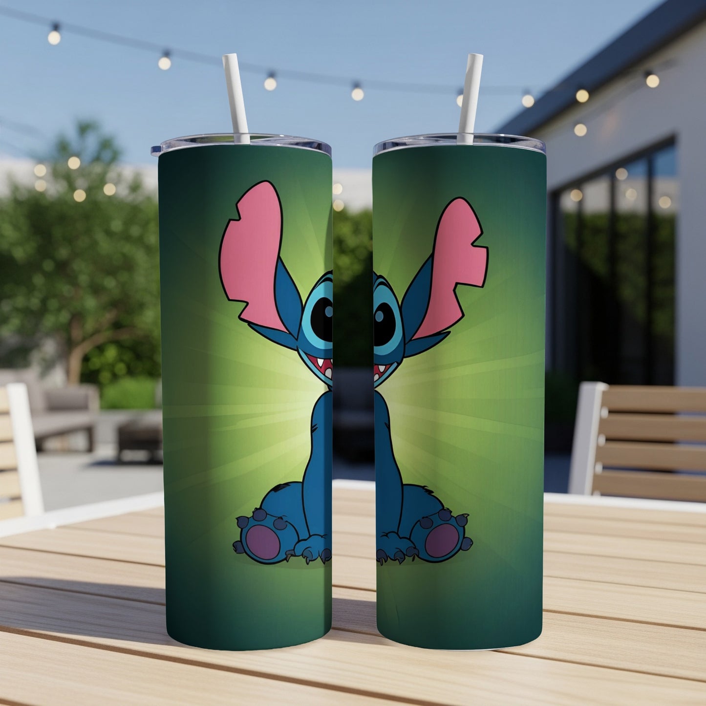 Two blue Stitch tumblers with straws on a wooden table.
