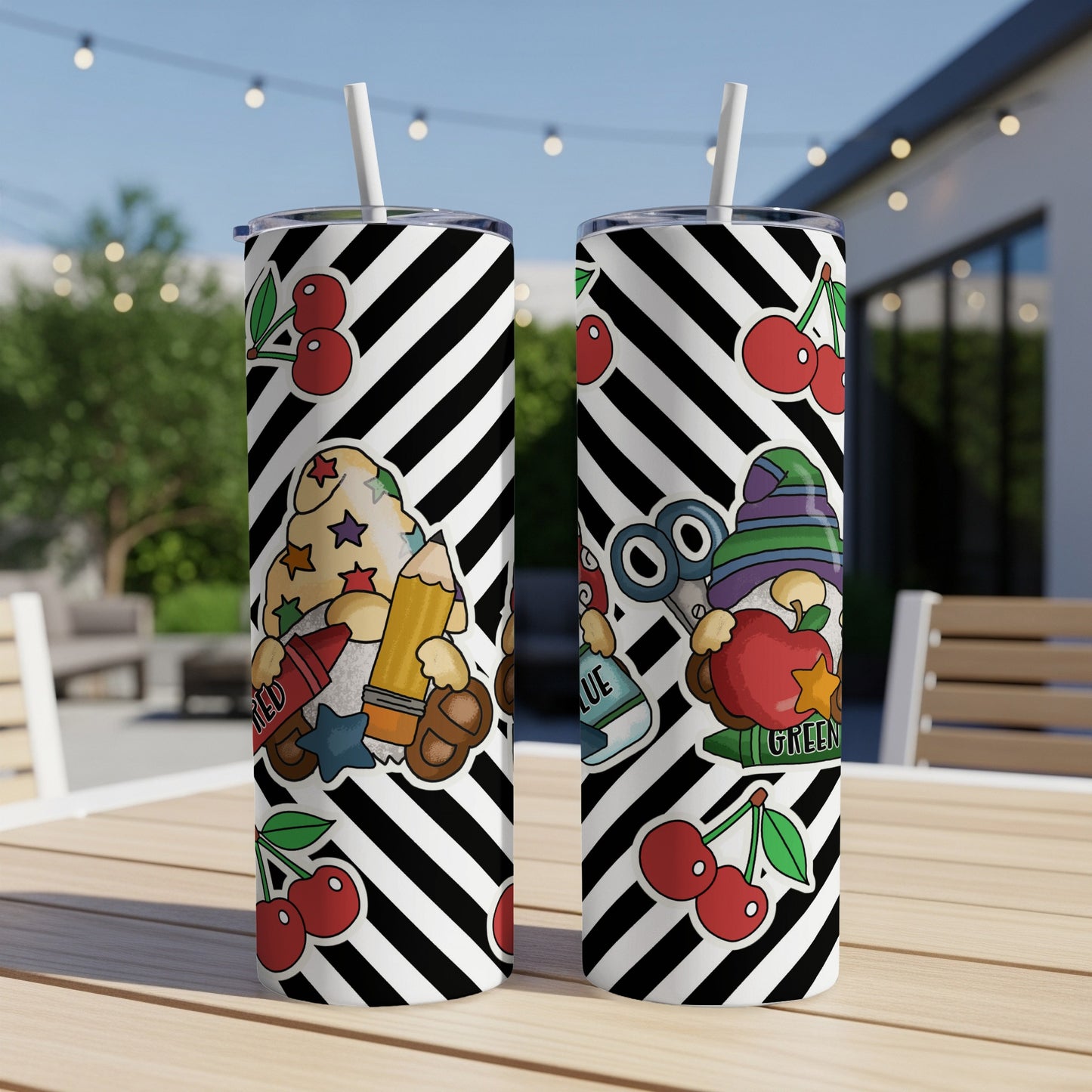 Two tumblers with black and white stripes and cartoon school supplies graphics.