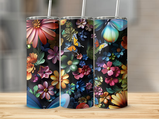 Three tumblers with floral and butterfly designs on a wooden surface.