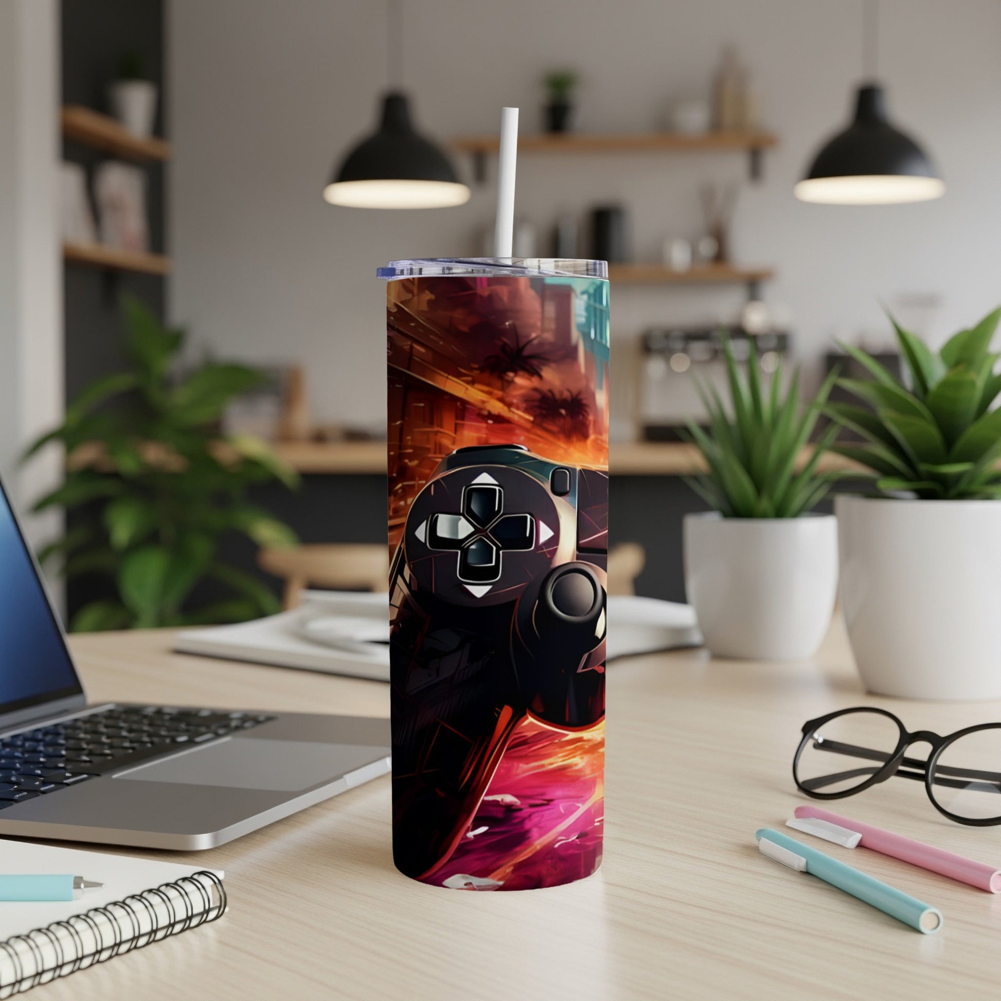Video game controller graphic on a tumbler with a straw.