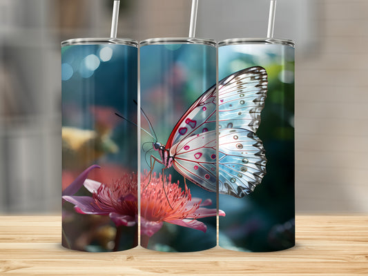 Butterfly on pink flower, displayed on three tumblers.