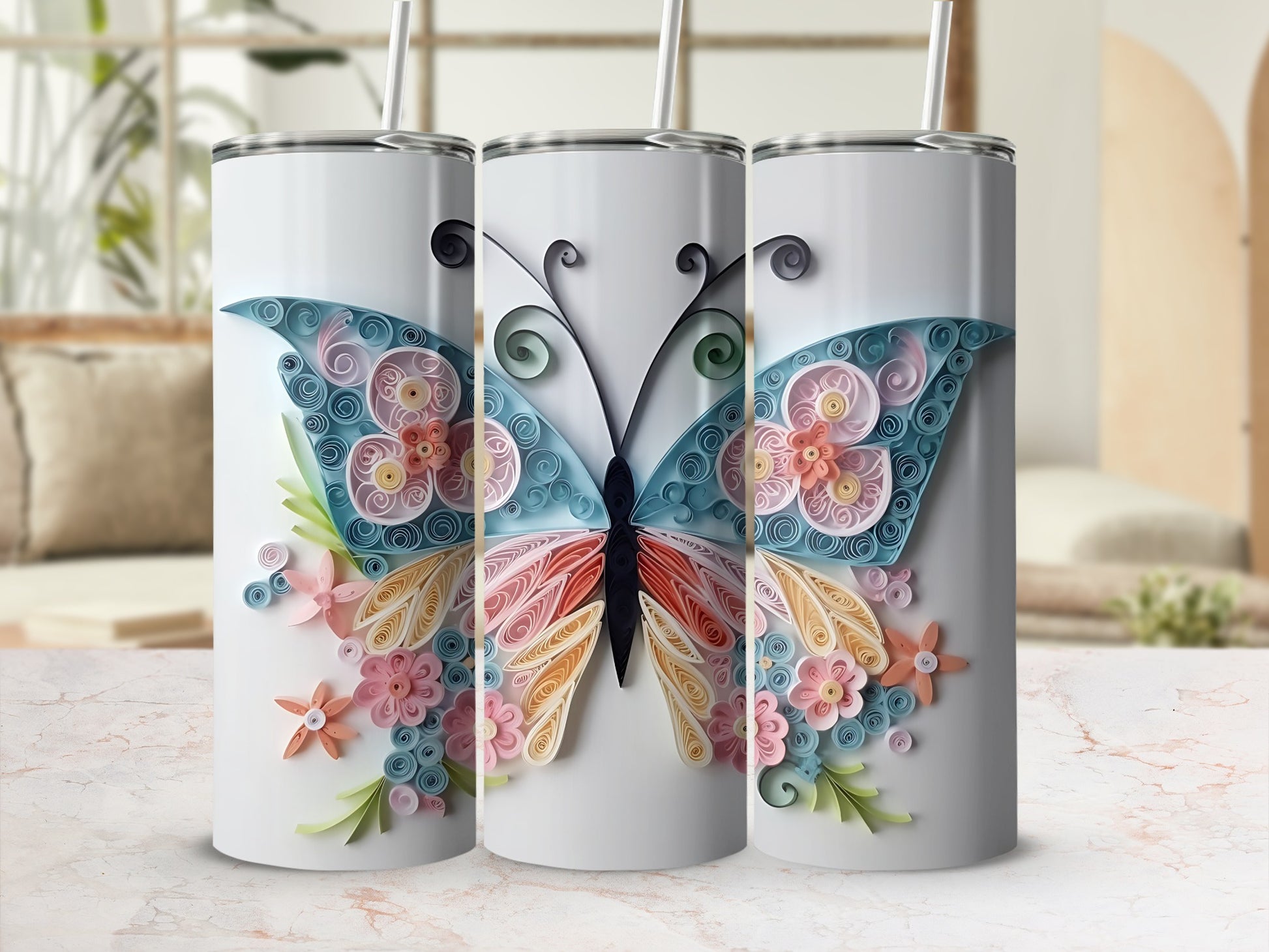 Three tumblers with a quilled butterfly and floral design.