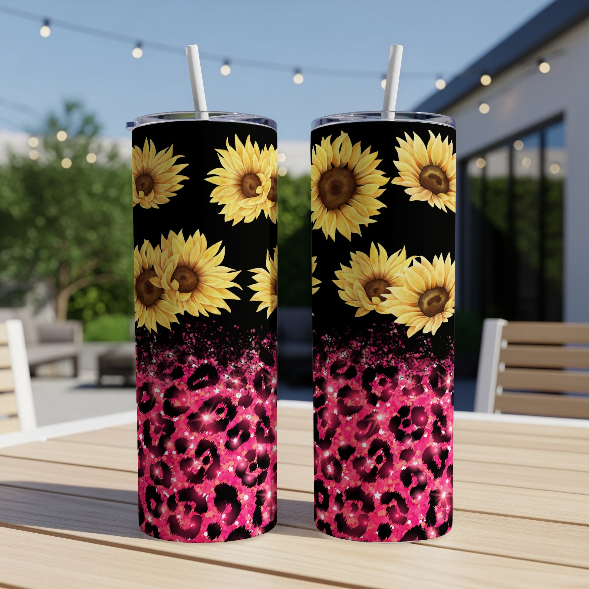 Two tumblers with sunflowers and pink leopard print on a table.