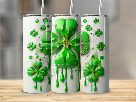 Three green shamrocks with dripping paint on white tumblers.